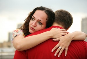 The crying girl embraces the man